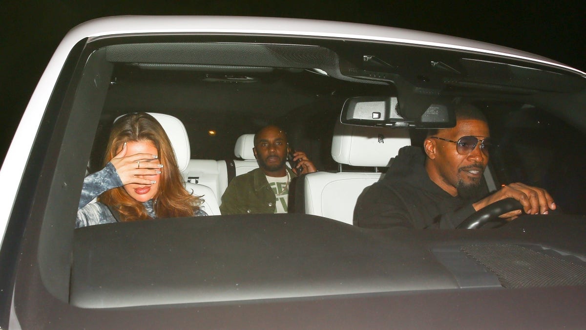 Jamie Foxx drives his Rolls Royce with other people in the car