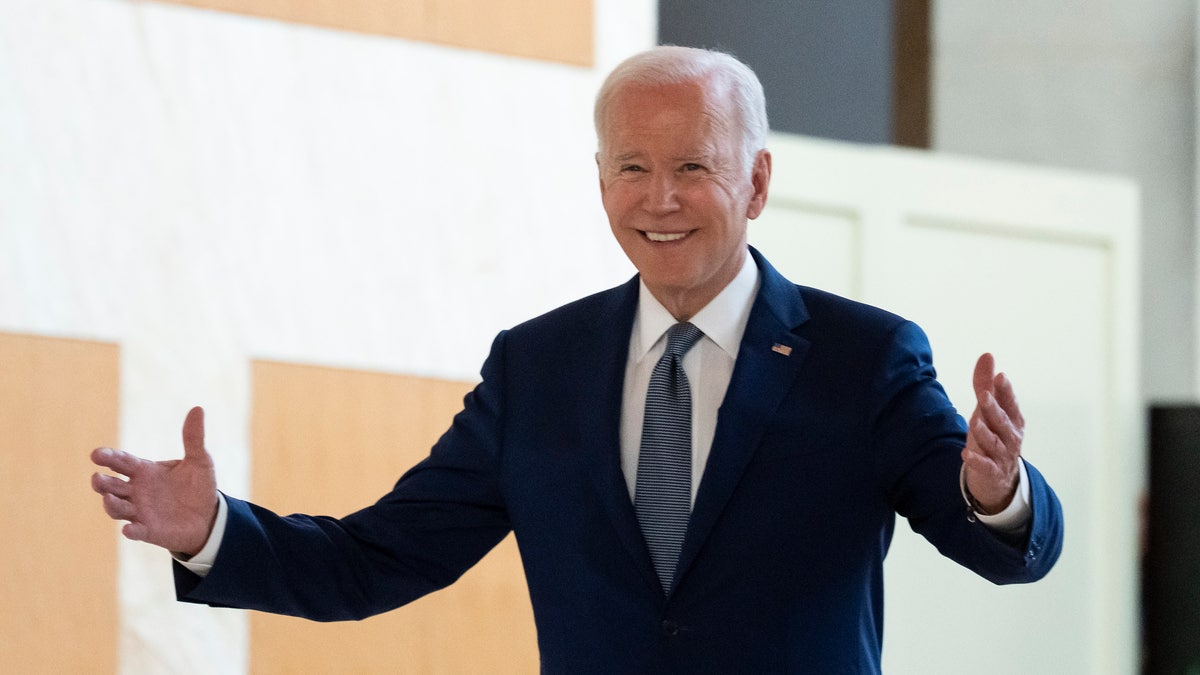 President Joe Biden walks toward Xi Jinping