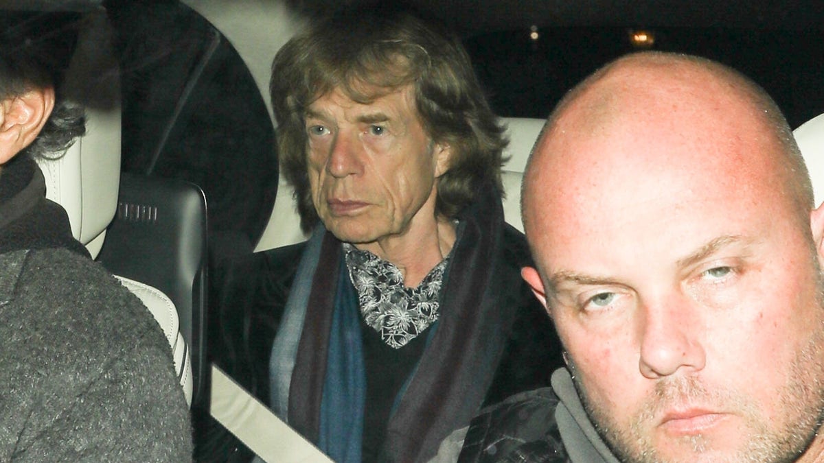 Mick Jagger sits in the backseat as he is driven to Leo DiCaprio's birthday party