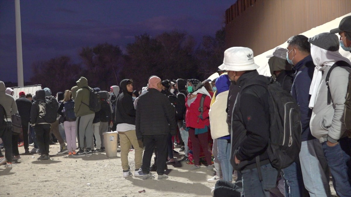 Migrants line up to be processed in Yuma
