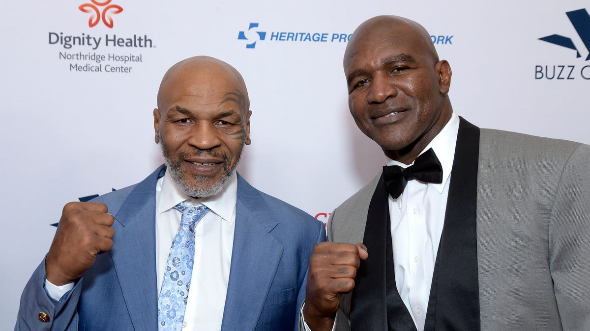 Mike Tyson and Evander Holyfield pose with fists