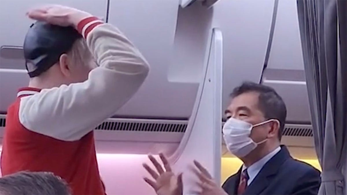 Passenger demands water as male flight attendant tries to calm him down