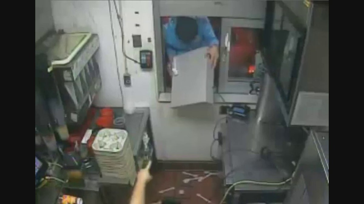 robber stealing cash register