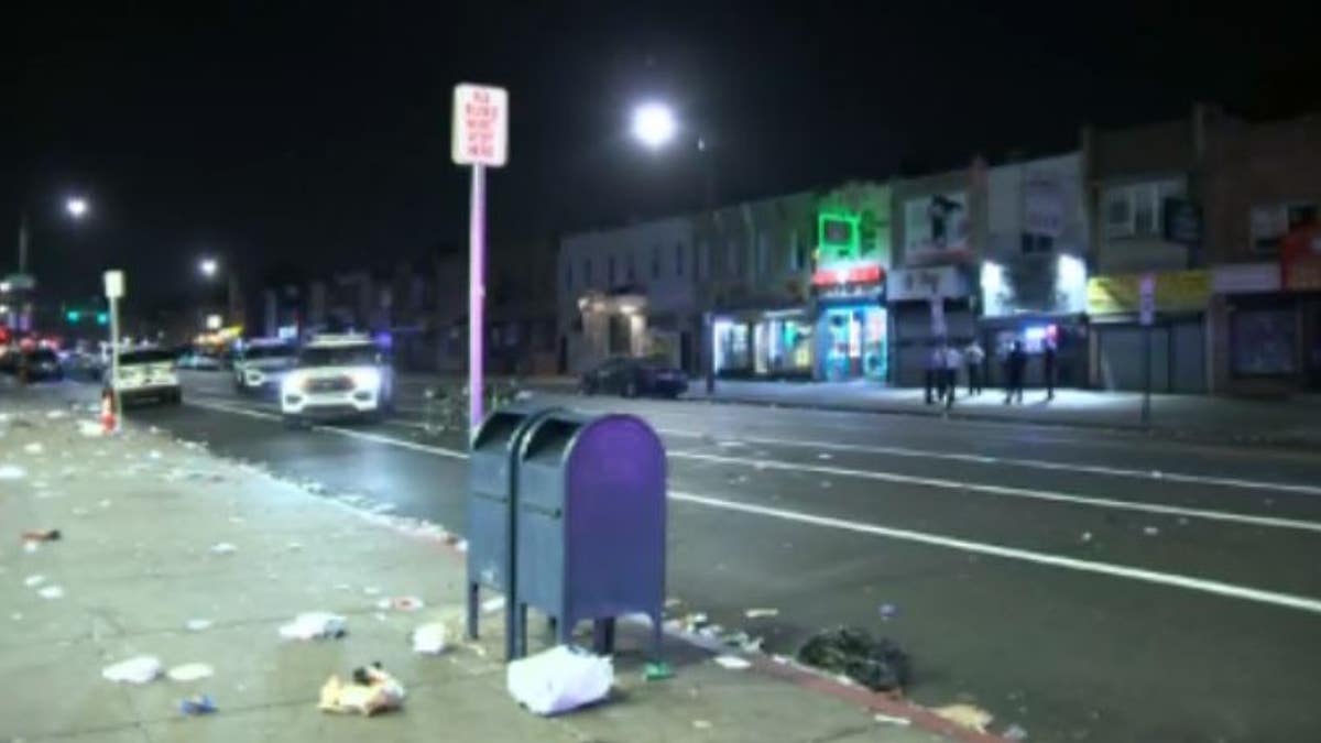 Trash lines an empty business district after a shooting