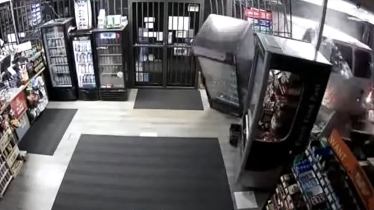 van driving through storefront