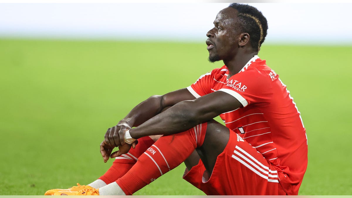 Sadio Mane sits on grass