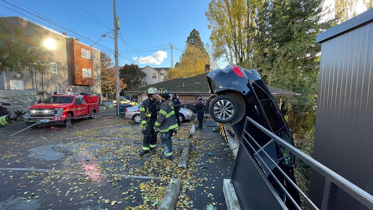 firefighters working near crashed car