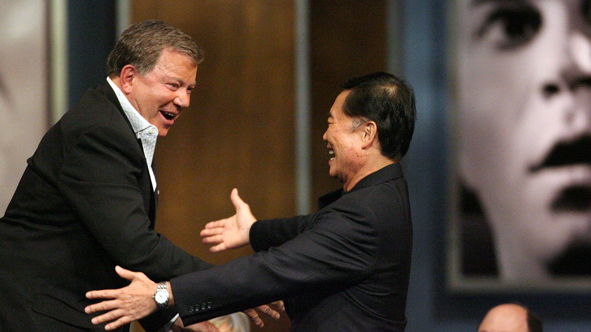 William Shatner and George Takei greeting each other