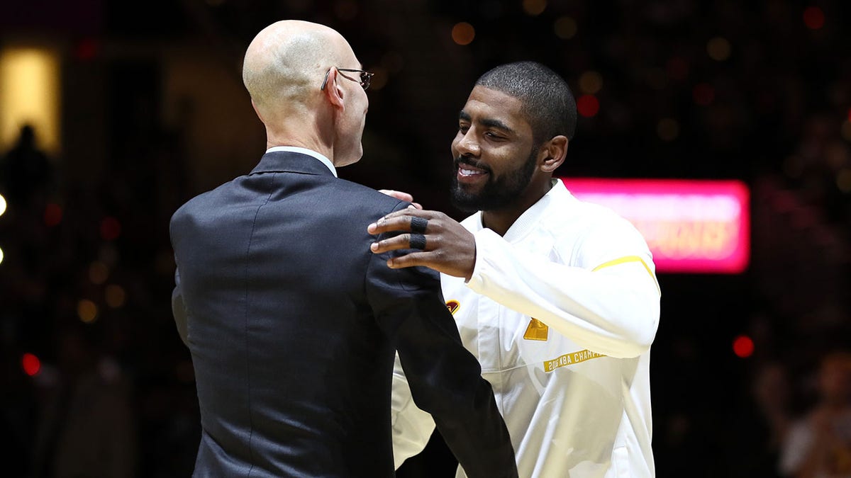 Adam Silver and Kyrie Irving shake hands