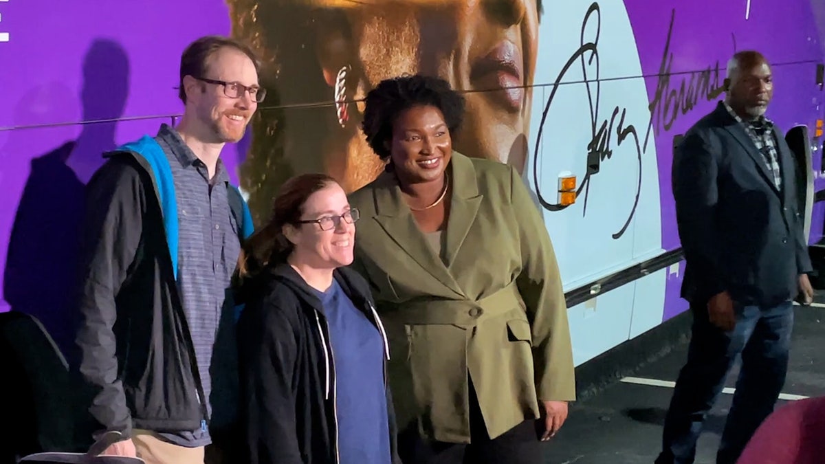 Georgia governor candidate Stacey Abrams poses for photos in front of tour bus