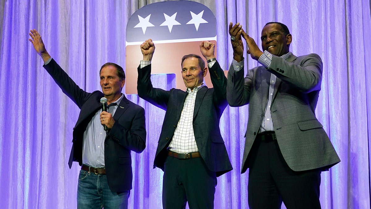 Reps. Chris Stewart, John Curtis, Burgess Owens on stage in celebration