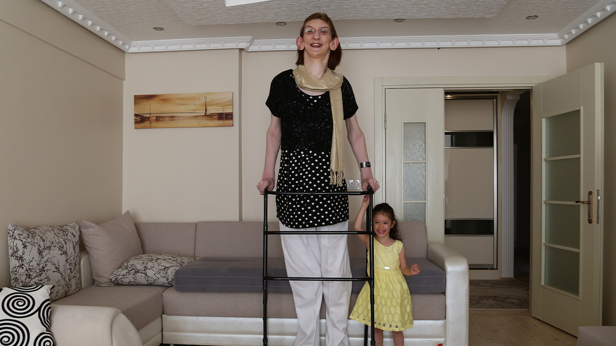 Tallest woman stands next to child