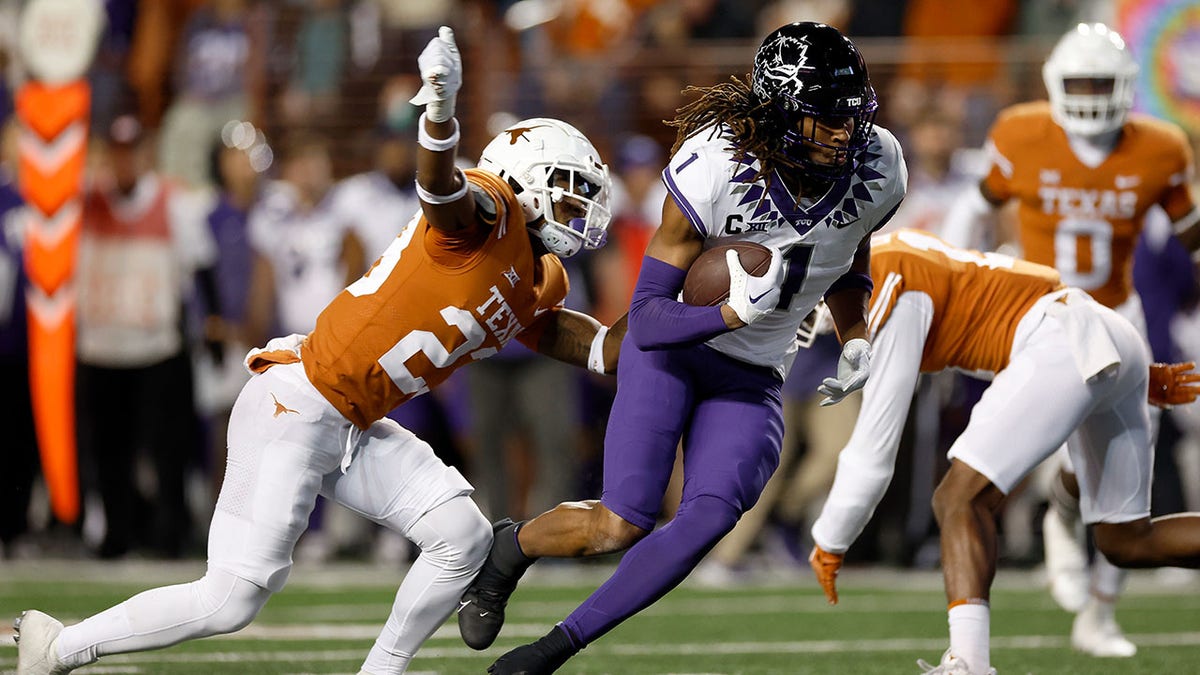 Quentin Johnston #1 of the TCU Horned Frogs runs after a catch while defended by Jahdae Barron #23 of the Texas Longhorns in the first quarter of the game at Darrell K Royal-Texas Memorial Stadium on November 12, 2022 in Austin, Texas.?