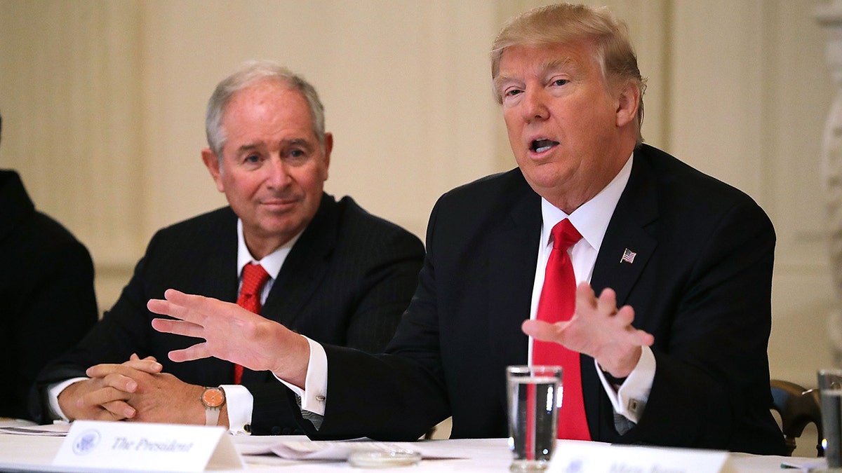 U.S. President Donald Trump (R) delivers opening remarks at the beginning of a policy forum with business leaders chaired by Blackstone Group CEO Stephen Schwarzman 