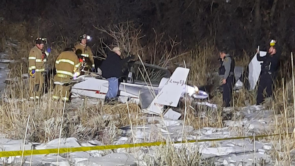 Firefighters around plane wreckage