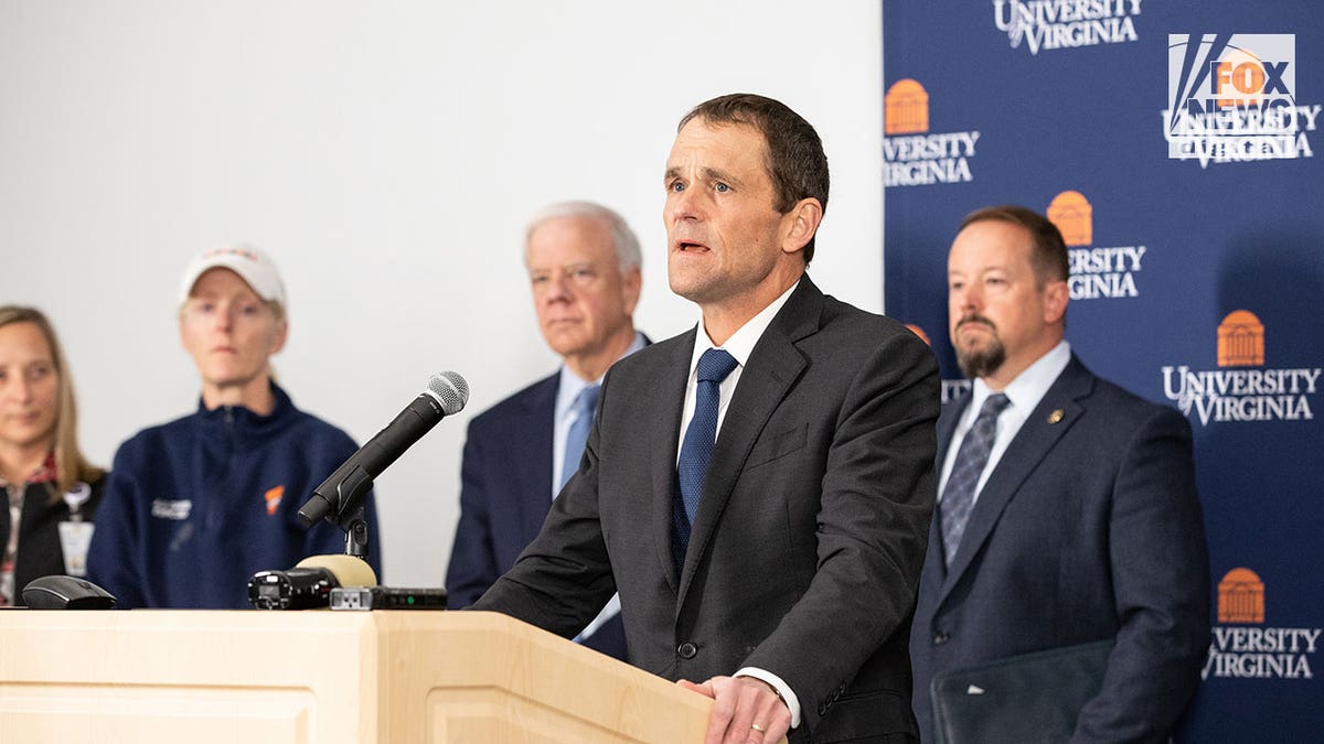 UVA president Jim Ryan wears suit and tie at podium during press conference on shooting