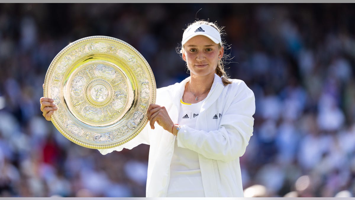 Elena Rybakina holds up trophy