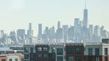 Jersey City in foreground with manhatten skyline in the background