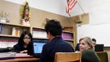 DENVER, CO - JANUARY 23: Middle school reading and social studies teacher Linda Digan speaks with students Israel Garcia (center) and Kaurys Bermudez (left) at St. Francis de Sales Catholic School on Tuesday, January 23, 2018. The school will become the first Catholic STEM (SCIENCE, TECHNOLOGY, ENGINEERING, MATH) school in Denver this fall. School leaders say the becoming a STEM school will further enhance the teaching and learning efforts while still following the curriculum set in place by the Archdiocese of Denver Catholic Schools. (Photo by AAron Ontiveroz/The Denver Post via Getty Images)