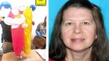 Photo of Sheila Keen Warren and officer holding up clown costume