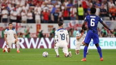 England's players take a knee before kickoff in World Cup match against the US