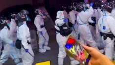 China deploys riot police in hazmat suits to crack down on COVID protests