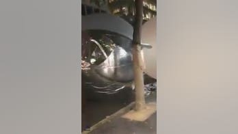 Giant Christmas baubles break free of display, go rolling and bouncing down street, startling drivers