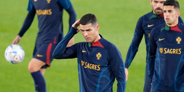 Cristiano Ronaldo, capital, scratches his head during a Portugal national team training session in Oeiras, outside Lisbon, on Monday.