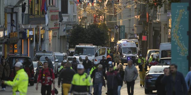 People leave the area after an explosion on Istanbul's popular pedestrianized Istiklal Avenue on Sunday, Istanbul, Sunday 13 November 2022. A bomb exploded Sunday on a major pedestrian street in the heart of Istanbul, killing a handful of people, injuring dozens and sending people on the run as the flames rose.