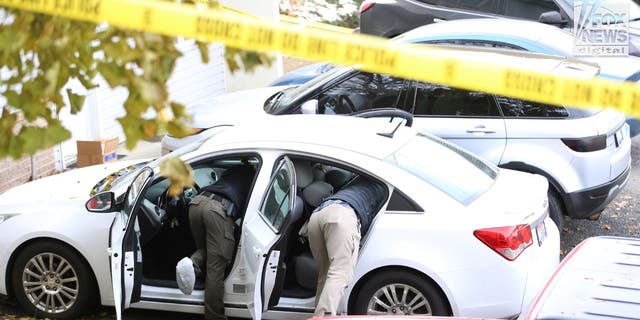 Investigators search a vehicle near the scene of a Nov. 13, 2022, quadruple homicide near the University of Idaho.