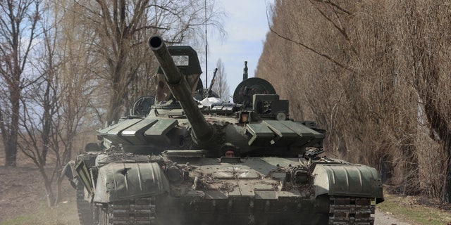 A Ukrainian service member drives a captured Russian T-72 tank, such as in the liberated village of Lukianivka, Kiev region, Ukraine.  