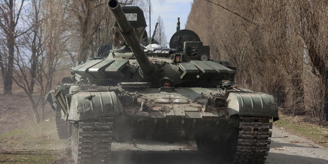 A Ukrainian service member drives a captured Russian T-72 tank, such as in the liberated village of Lukianivka, Kiev region, Ukraine.  