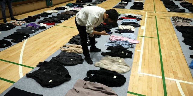 Belongings of victims are photographed at a gym, where recovered belongings of the victims of a crowd crush that happened during Halloween festivities are kept, in Seoul, South Korea, Nov. 1, 2022. 
