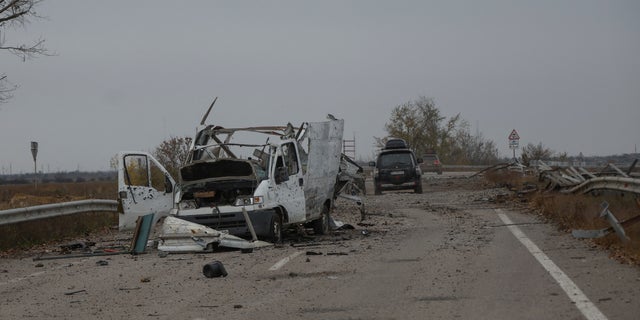 The wrecked car is seen on a highway to the city of Kherson during the Russian attack on Ukraine in the Kherson region of Ukraine on November 11, 2022.  