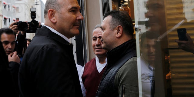 Interior Minister Suleyman Soylu talks to shop owners as he visits the blast site on Istiklal Avenue in Istanbul, Turkey, Nov. 14, 2022.