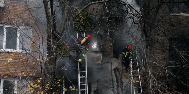Firefighters work to put out a fire in a residential building hit by a Russian strike amid Russia's attack on Ukraine, in Kyiv, Ukraine Nov. 15, 2022.