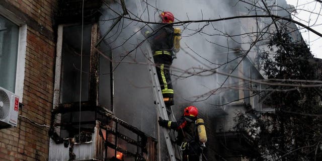 Firefighters work to put out a fire in a residential building hit by a Russian missile strike, amid Russia's attack on Ukraine, in Kyiv, Ukraine Nov. 15, 2022. 