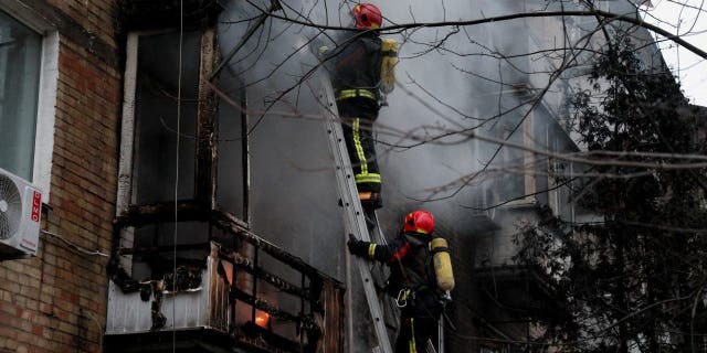 Firefighters work to put out a fire in a residential building hit by a Russian missile strike, amid Russia's attack on Ukraine, in Kyiv, Ukraine Nov. 15, 2022.