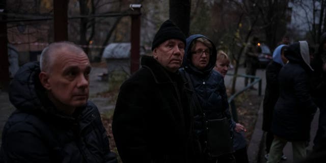 Local residents gather near their residential building hit by a Russian missile strike, amid Russia's attack on Ukraine, in Kyiv, Ukraine Nov. 15, 2022. 
