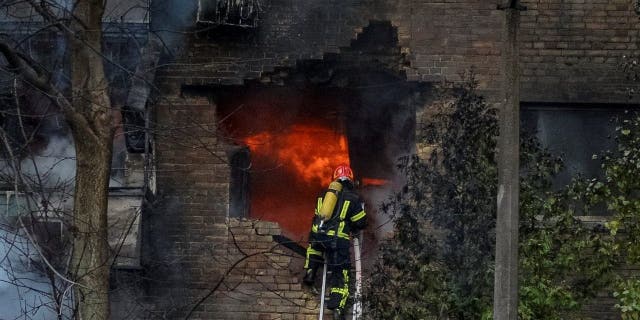 Firefighters work to put out a fire in a residential building hit by a Russian missile strike, amid Russia's attack on Ukraine, in Kyiv, Ukraine November 15, 2022.