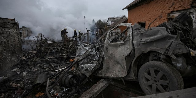 Rescuers work near houses heavily damaged by a Russian missile attack in Dnipro, Ukraine, on November 26, 2022.