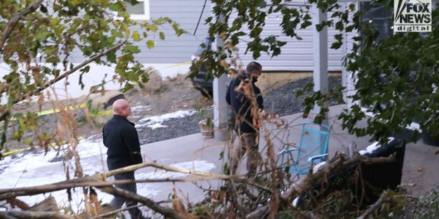 Investigators outside the home where four University of Idaho students were found fatally stabbed.