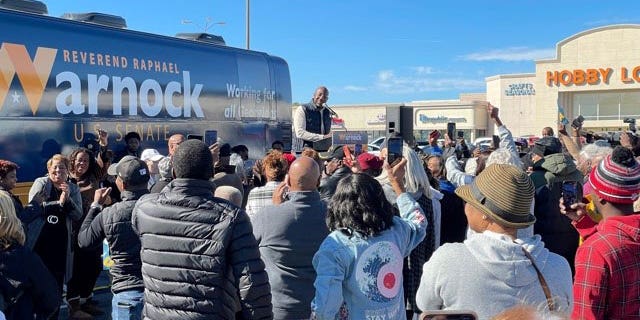 Georgia Democratic Sen. Raphael Warnock speaks to a crowd of supporters in Conyers, Georgia, on Nov. 21, 2022.