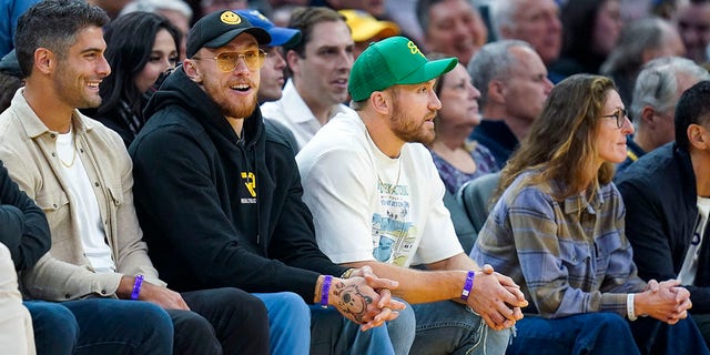 From left to right, San Francisco 49ers' Jimmy Garoppolo, George Kittle and Kyle Juszczyk sit courtside during the first half of an NBA basketball game between the Golden State Warriors and the San Antonio Spurs in San Francisco, Monday, Nov. 14, 2022.