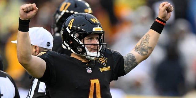 Taylor Heinicke #4 of the Washington Commanders celebrates after beating the Atlanta Falcons 19-13 at FedExField on November 27, 2022 in Landover, Maryland.