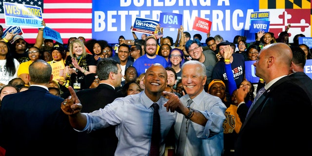 President Joe Biden poses for photos with gubernatorial candidate Wes Moore during a campaign rally at Bowie State University in Bowie, Maryland, Monday, Nov. 7, 2022.