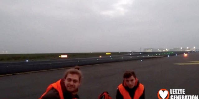 Members of the climate change activist group The Last Generation are glued to the runway at the airport in Berlin, Germany.