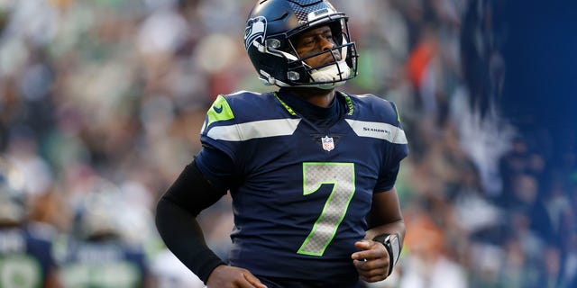 Geno Smith of the Seattle Seahawks jogs down the field in the third quarter against the Las Vegas Raiders at Lumen Field on November 27, 2022 in Seattle, Washington.