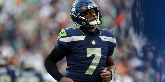 Geno Smith of the Seattle Seahawks jogs down the field in the third quarter against the Las Vegas Raiders at Lumen Field on November 27, 2022 in Seattle, Washington.