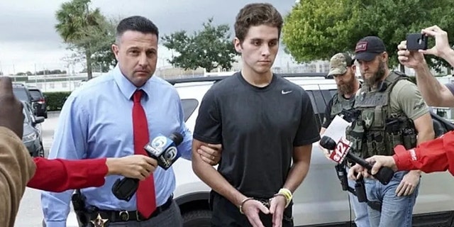 Austin Harrouff is transported by detectives to the Martin County Jail from St. Mary's Hospital in Stuart, Fla. A forensic psychologist says Harrouff, a former college student believed he was "half-dog, half-man" when he fatally attacked a man and woman at their home and was found biting one of their faces.